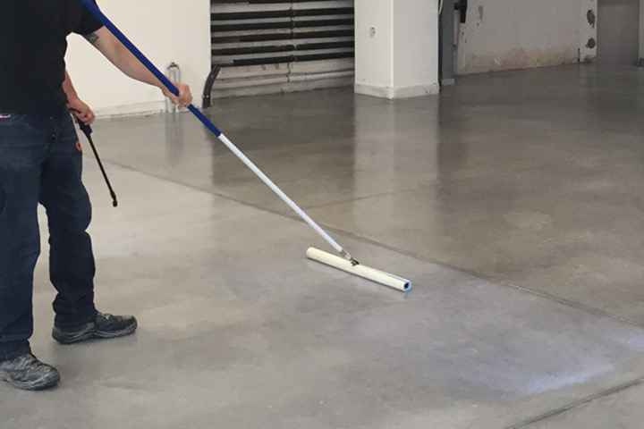 Applicazione del trattamento GiGi su pavimenti in calcestruzzo con uno speciale strumento a T in microfibra.
